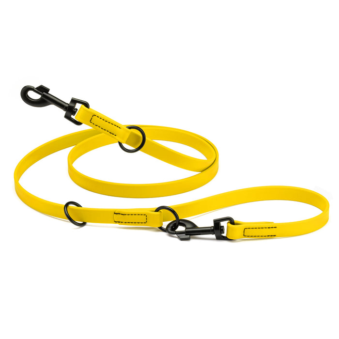 Lemon yellow adjustable dog leash with two metal clips and three O-rings, made from waterproof Biothane